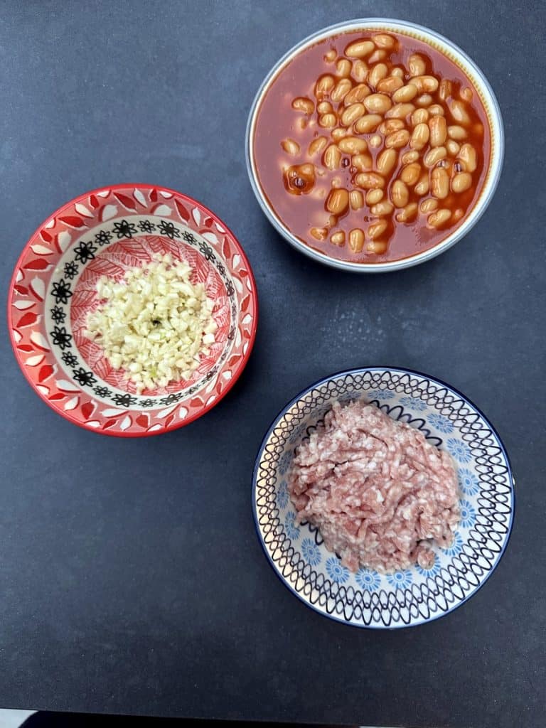 Ingredients, baked beans, chopped garlic, minced pork