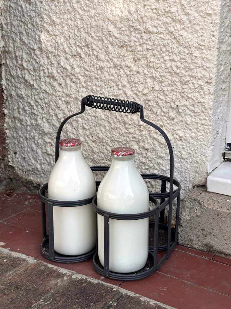 How to Host a Sustainable Dinner Party: Practical Tips for Eco-Conscious Entertaining 2 Glass milk bottles from milkman