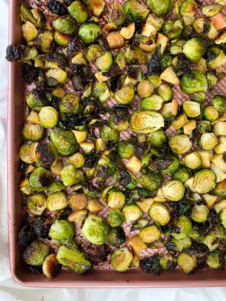 This Honey Roasted Brussel Sprouts and Apples recipe is ready in 30 minutes, made using four simple ingredients, and is the perfect side to any meal! Enjoy this quick and easy recipe at your next family gathering or potluck. #healthyrecipes #brusselsprouts #easyrecipe #fallrecipe