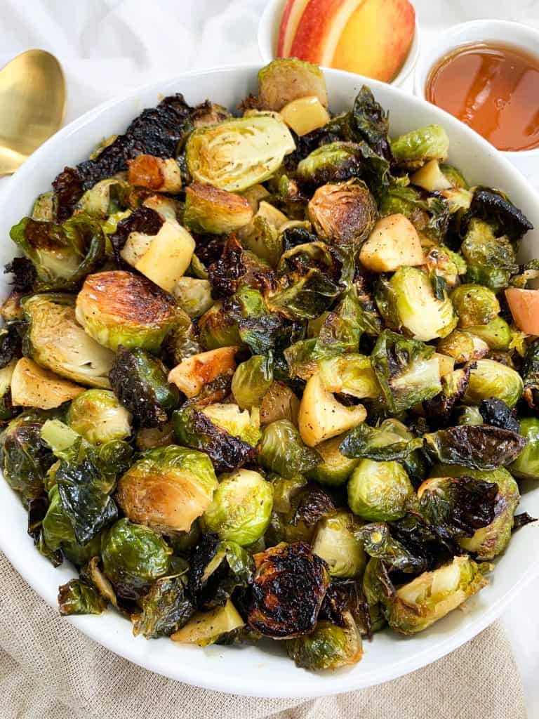 This Honey Roasted Brussel Sprouts and Apples recipe is ready in 30 minutes, made using four simple ingredients, and is the perfect side to any meal! Enjoy this quick and easy recipe at your next family gathering or potluck. #healthyrecipes #brusselsprouts #easyrecipe #fallrecipe