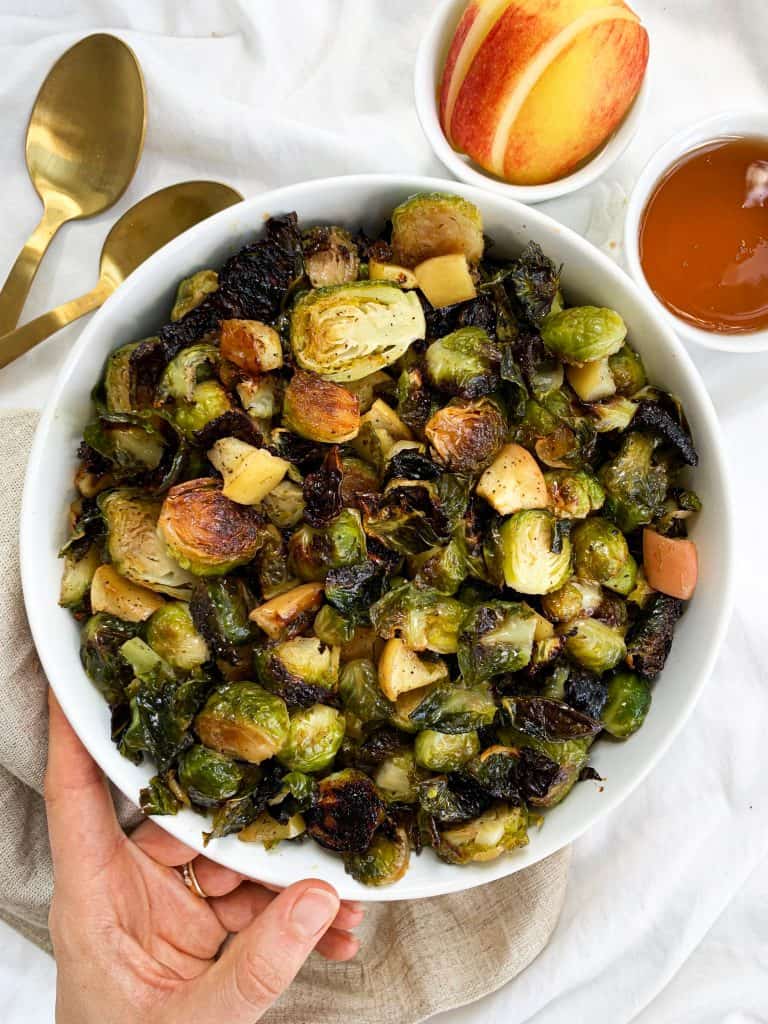 This Honey Roasted Brussel Sprouts and Apples recipe is ready in 30 minutes, made using four simple ingredients, and is the perfect side to any meal! Enjoy this quick and easy recipe at your next family gathering or potluck. #healthyrecipes #brusselsprouts #easyrecipe #fallrecipe