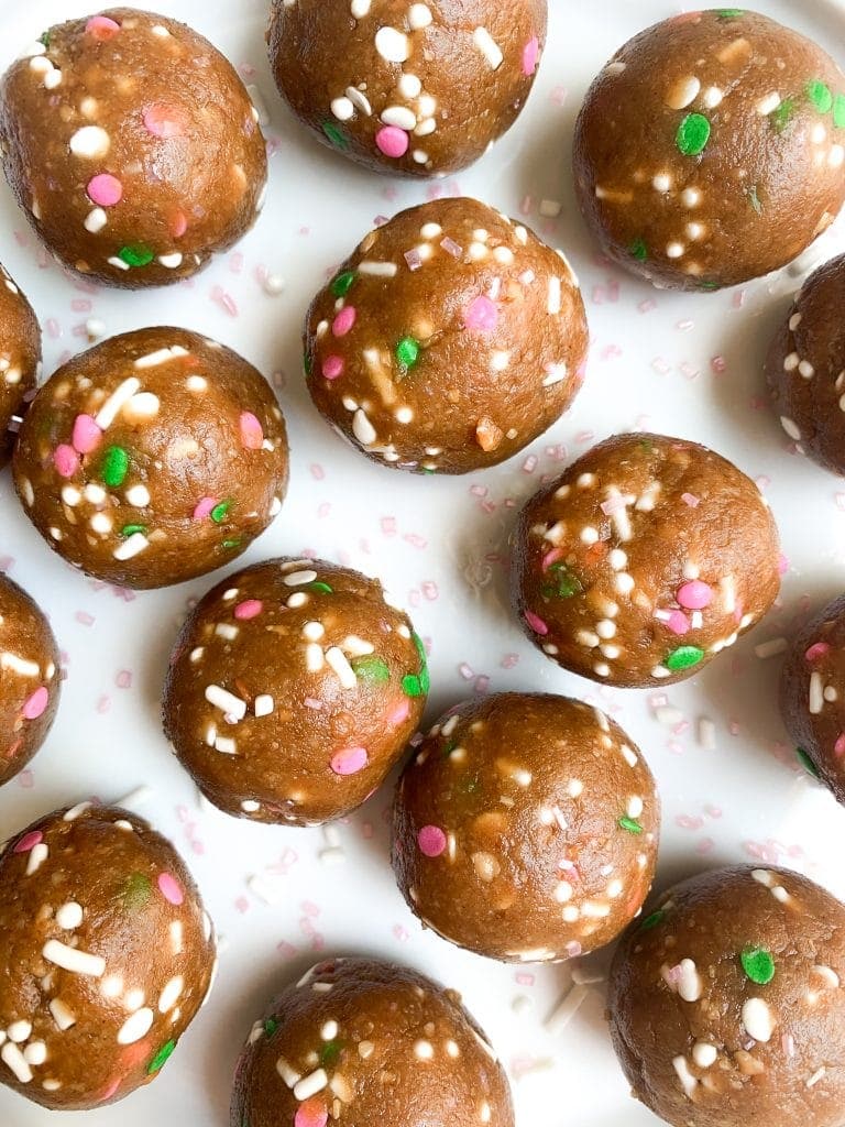 close up of vegan cookie dough balls on white plate