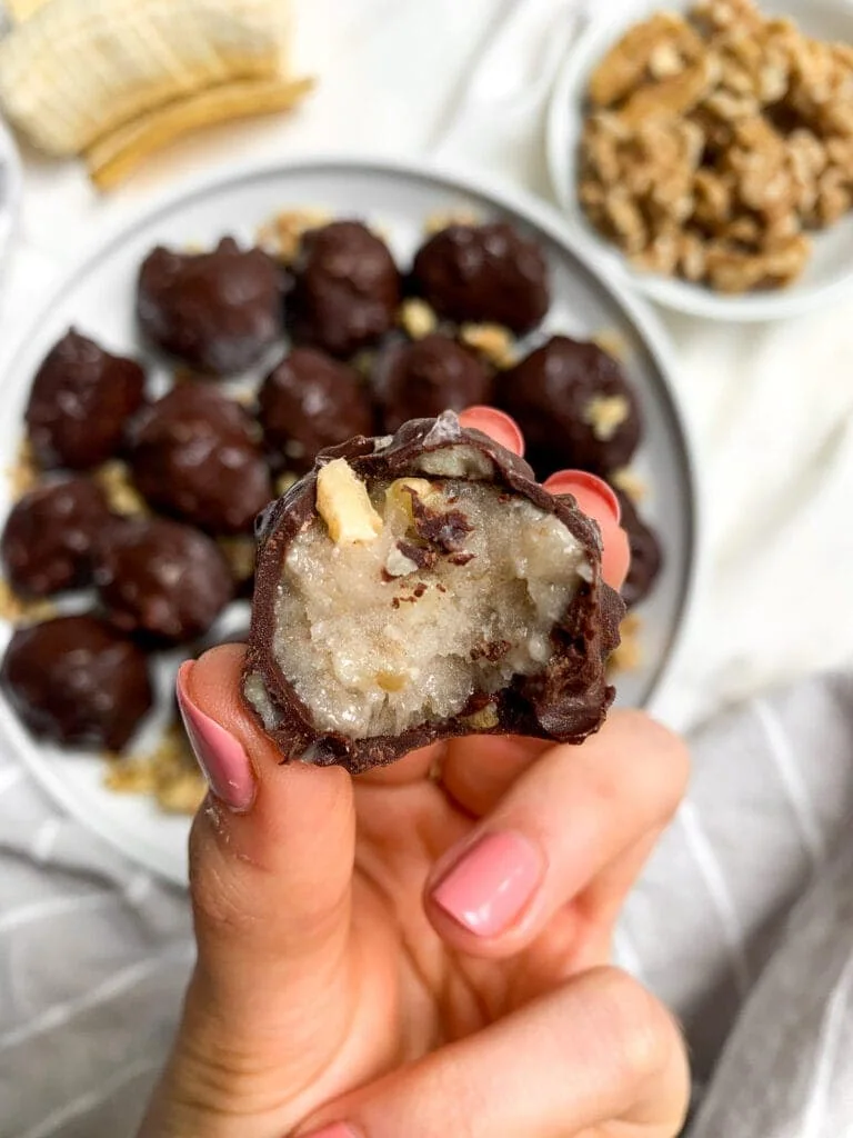 Chocolate dipped ice cream ball with bite taken out