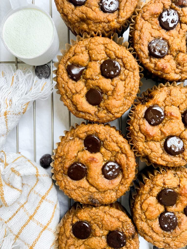 top view of fresh batch of pumpkin protein muffins on wire rack