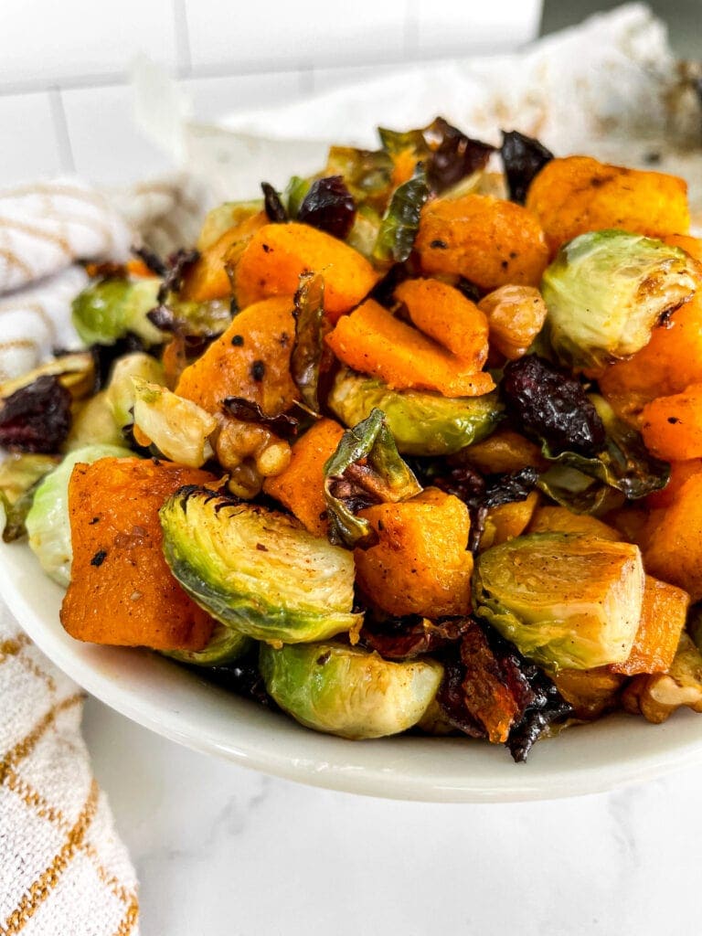 butternut squash and brussels sprouts in a large serving dish