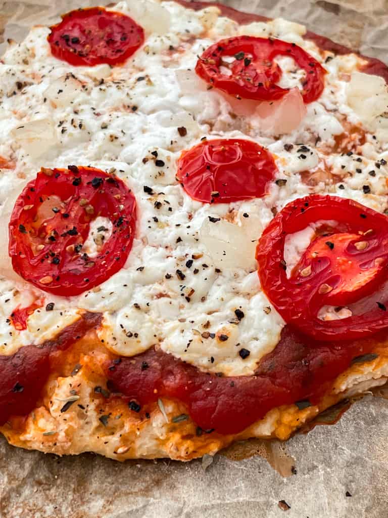 High protein pizza with cheese and tomatoes.