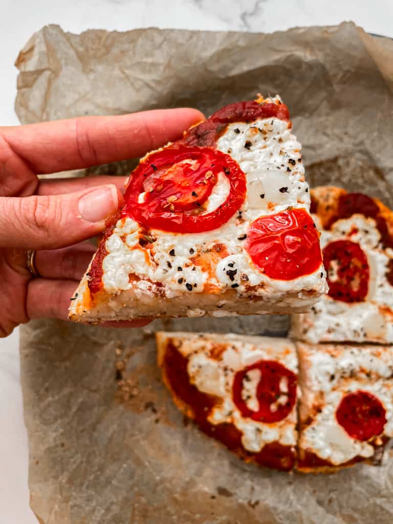 Picking up a piece of high protein pizza. 