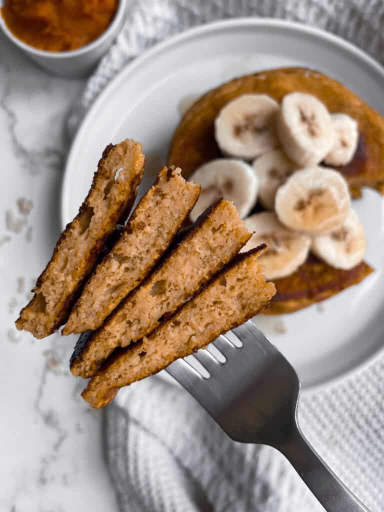 A bite of cottage cheese pumpkin pancakes on a fork.