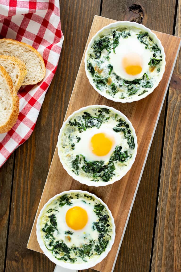 baked eggs in ramekins with spinach and cream