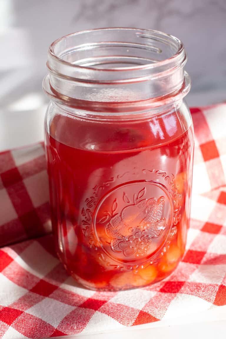 mason jar filled with sour cherry shrub
