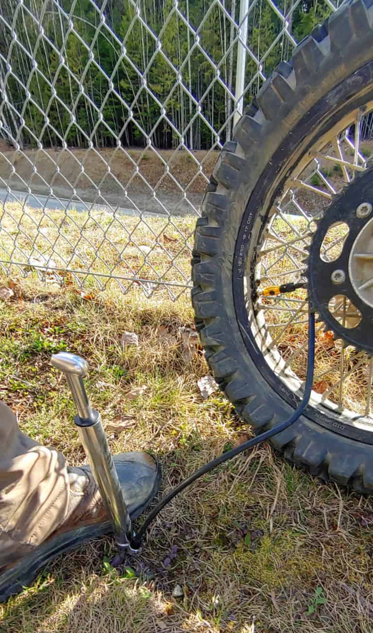 pumping up a motorcycle tire