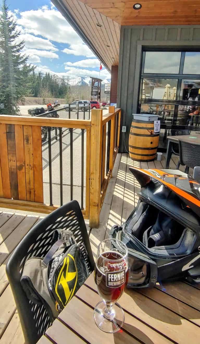 motorcycle helmet and beer outside Fernie Brewing