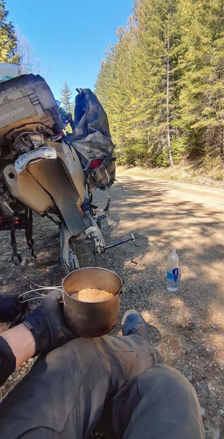 fixing a flat tire on a motorcycle having lunch