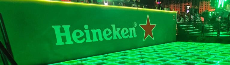 LED dance floor with Heineken branding and vibrant green lighting. Perfect for corporate events and.