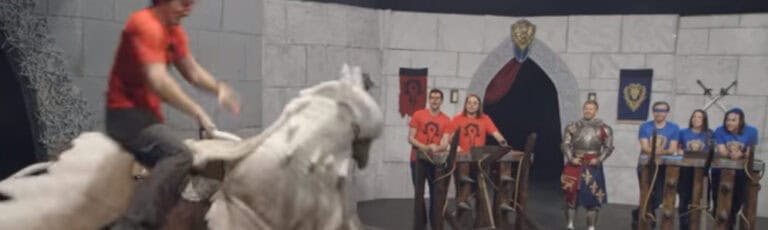 Participants riding a mechanical bull during Warcraft Challenge TV episode in Los Angeles.