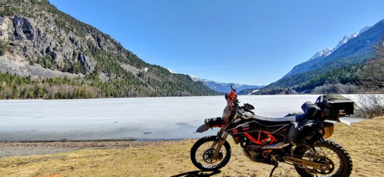 a picture of a frozen summit lake with motorcycle