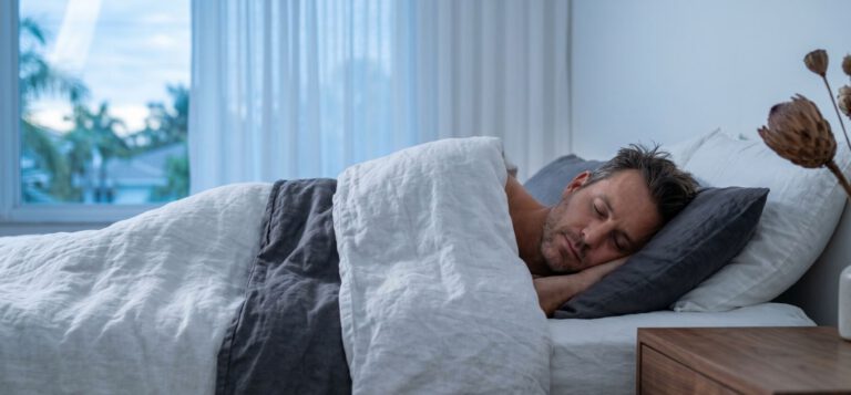 Man doing his morning stretch in a quiet Sarasota bedroom at first light