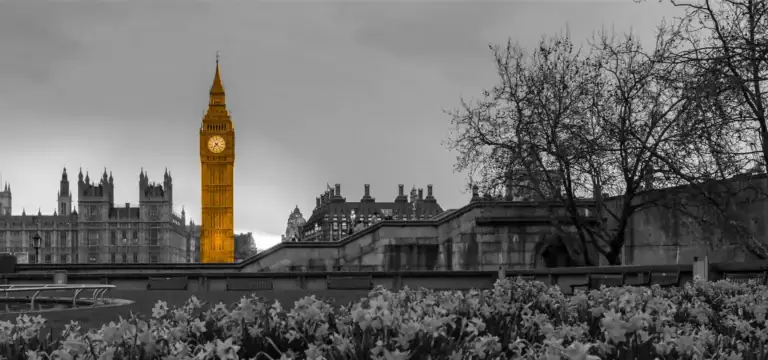 A black and white image of London, with an orange clock tower