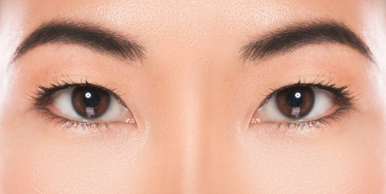 Close-up of woman's face showing eyes and nose, highlighting smooth skin and natural eyelid contour for facial procedures