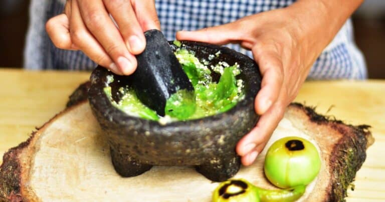 woman making salsa in one of the best cooking classes in oaxaca mexico