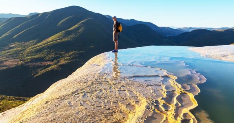 man standing at hierve el agua oaxaca mexico on one of the best hierve el agua tours