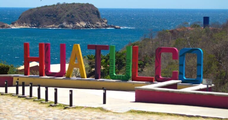 sign with colorful letters overlooking the beach