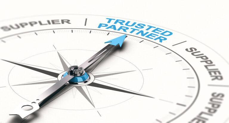 A compass with the word trusted partner on it.