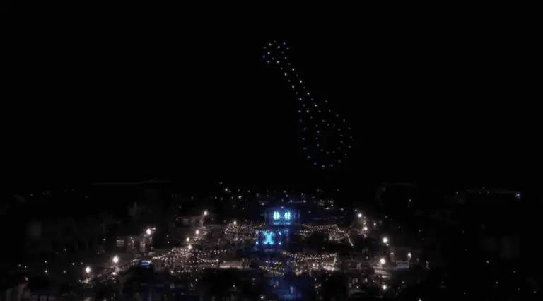 night sky over hard rock hotel in Punta Cana with hotel lit up and a 70 drone show displaying a colorful guitar