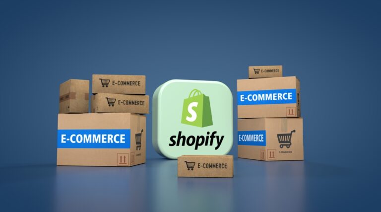 Shopify app icon between stacks of boxes with tape labeled “E-COMMERCE”