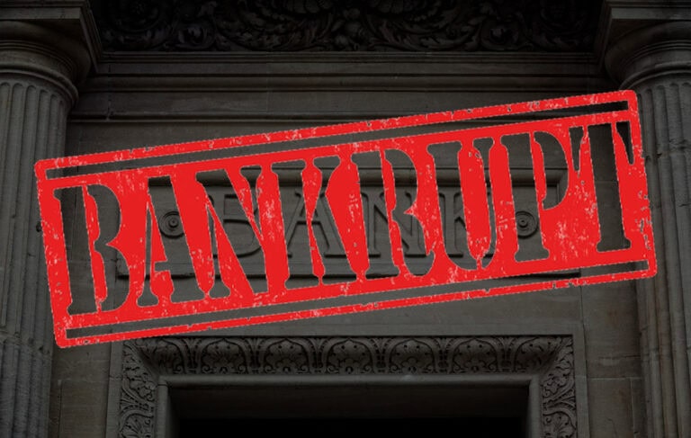 "Bankrupt" stamped in red over a traditional marble bank