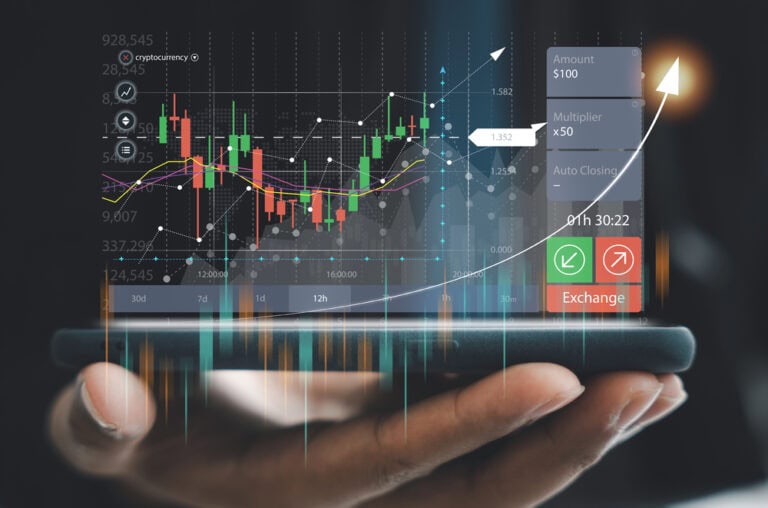 Businessman checking stock market trends and currency exchange rates on his mobile phone app. Economic growth and investment concept.