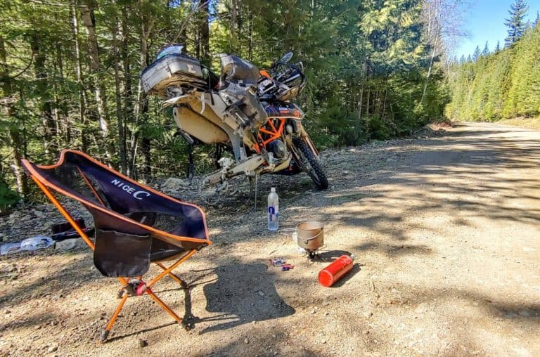 fixing a flat tire on a motorcycle having lunch
