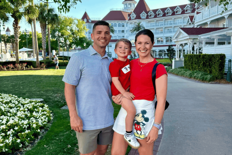 Family at Disney World resort with iconic architecture and lush gardens.