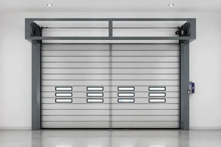 Interior view of an ABX automatic electric roll-up sectional door featuring modular panels, vision windows, and a wall-mounted smart control box for seamless industrial maintenance.