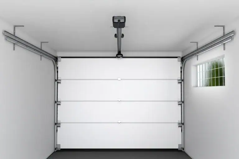 Interior view of an automatic commercial sectional door equipped with a ceiling-guided center-mount servo motor and standard lift tracks, specifically engineered for low-headroom installations requiring less than 35cm clearance.