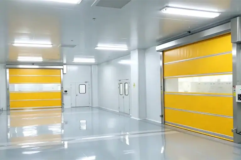 Interior view of an ISO-certified electronics cleanroom featuring yellow high-speed PVC industrial doors with stainless steel frames and transparent vision panels, engineered for strict contamination control in semiconductor manufacturing projects.