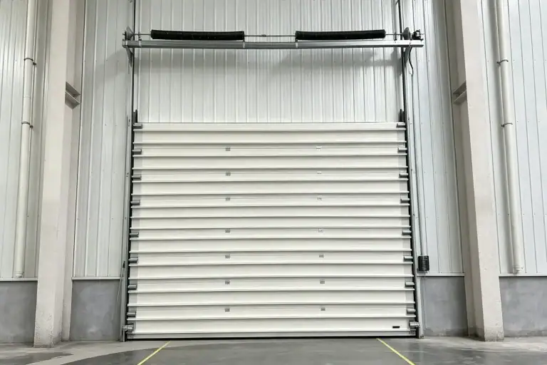 Custom Industrial Overhead Door Installed in a Modern Factory Building with Torsion Spring System