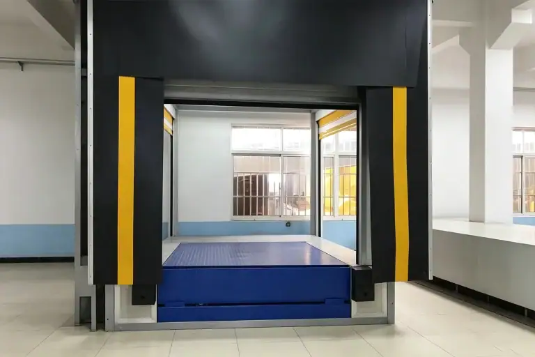 Front view of an industrial loading dock equipped with a yellow-striped dock shelter, retractable seal, and a blue hydraulic dock leveler inside a modern warehouse facility.