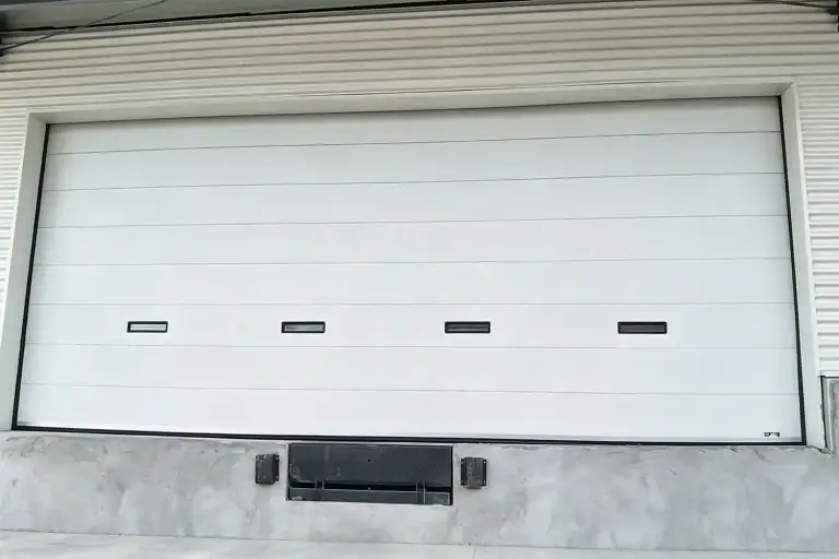 Fully Closed Heavy-Duty Industrial Sectional Overhead Door with Vision Windows at Warehouse Loading Dock