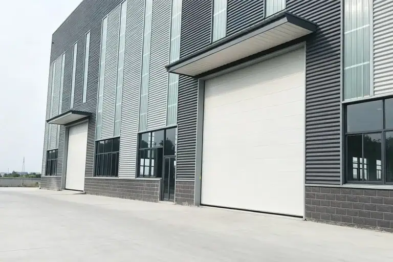 Modern Industrial Warehouse Exterior Facade Featuring Large White Sectional Overhead Doors and Canopies