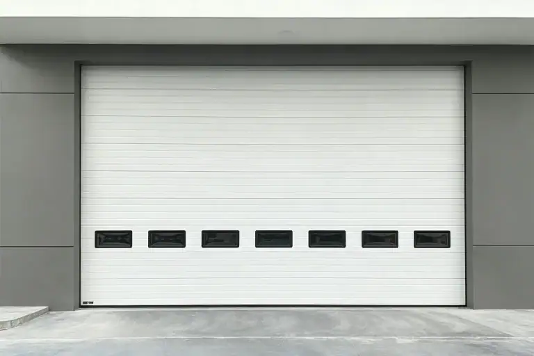 Wind rated industrial sectional door with vision windows engineered for ANSI DASMA 108 compliance by ABX Doors