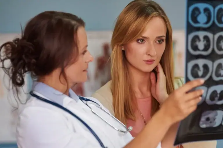 Physical therapist reviewing imaging with patient during post-operative rehabilitation consultation