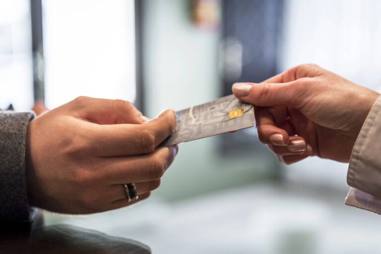 Credit card being passed from one hand to another