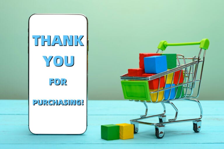 Full filled shopping cart with a mobile showing THANK YOU FOR PURCHASING