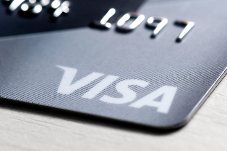 Detail of an international payment and withdrawal bank card with the Visa logo shot close-up. Visa is an American payment system used in most parts of the world