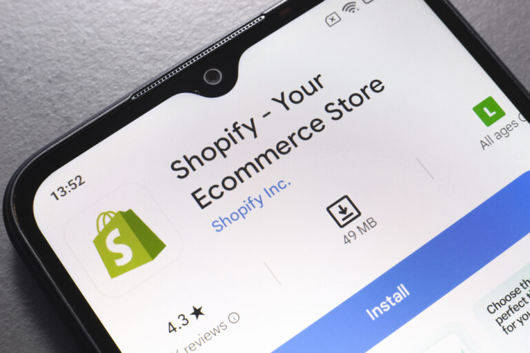 In this photo illustration, the Shopify app logo is displayed on a smartphone screen