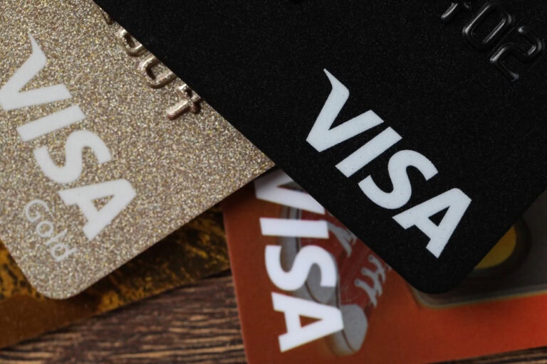Visa credit cards on wooden table, closeup
