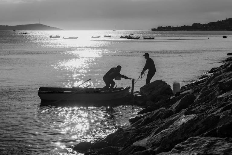 A man on a boat in stormy seas, depicting Jonah's flight from God's calling