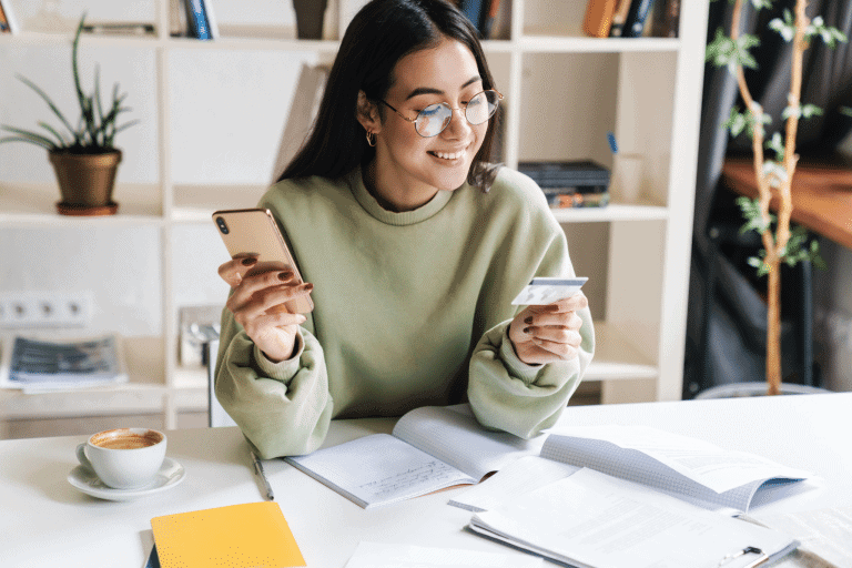 a women planning a trip using a credit card and smiling