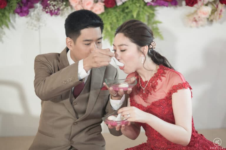 The bride and groom share sweet rice-ball soup during the tea ceremony at Dusit Thani Hua Hin